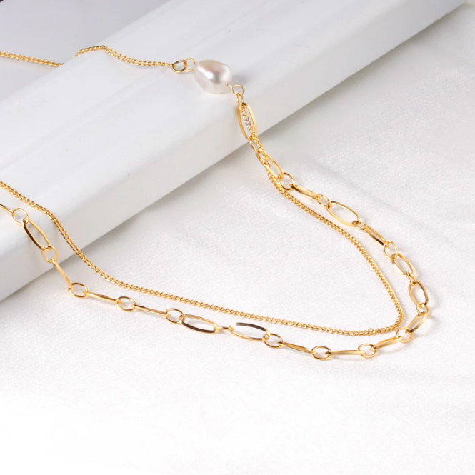 Gold chain necklace on a white background