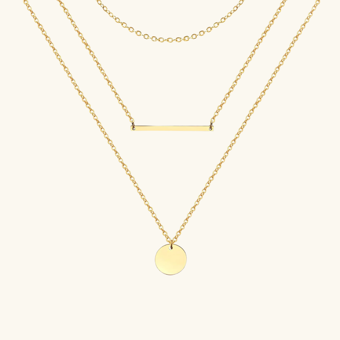 Two gold necklaces on a white background