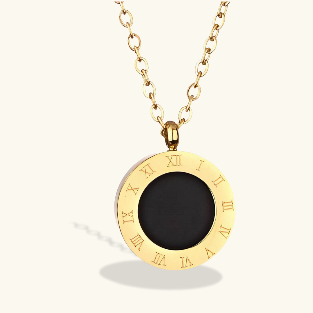 Gold necklace with a black pendant featuring Roman numerals on a white background