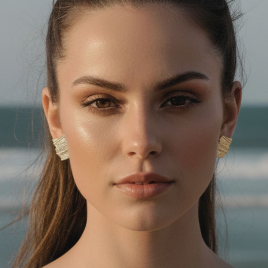 Close-up of a woman with earrings against a blurred natural background