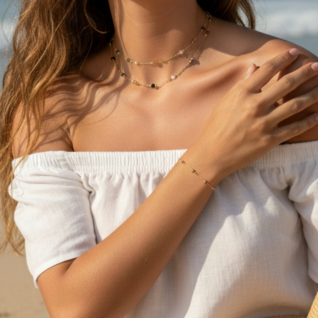 Woman wearing a beaded necklace and bracelet with a blurred background