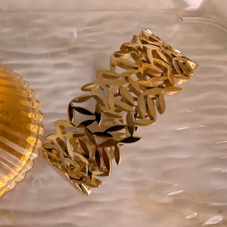 Gold bracelet on a textured surface