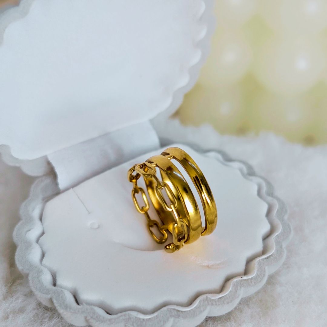 Gold rings on a white jewelry box with a soft focus background