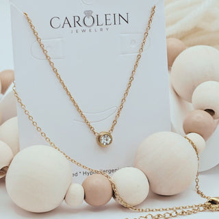 Necklace with white and pink beads on a CAROLEIN Jewelry card