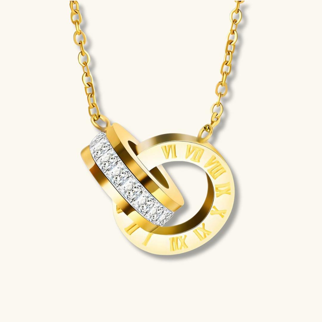 Gold necklace with a circular pendant featuring Roman numerals and small diamonds on a white background
