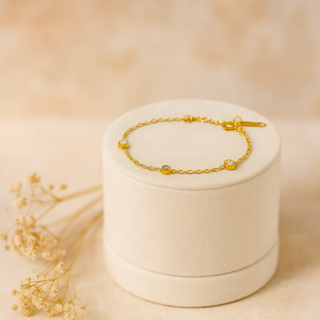 Gold bracelet on a white jewelry box with a soft beige background