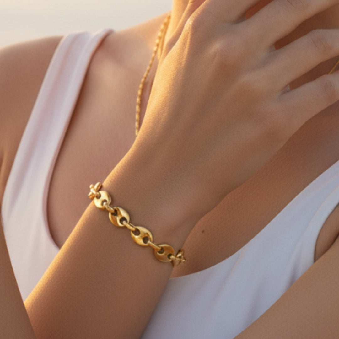 Gold bracelet on a wrist with a blurred background
