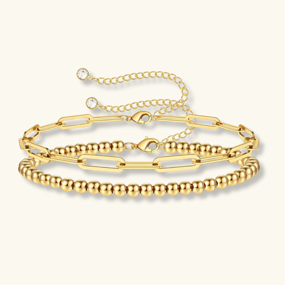 Set of gold bracelets on a white background