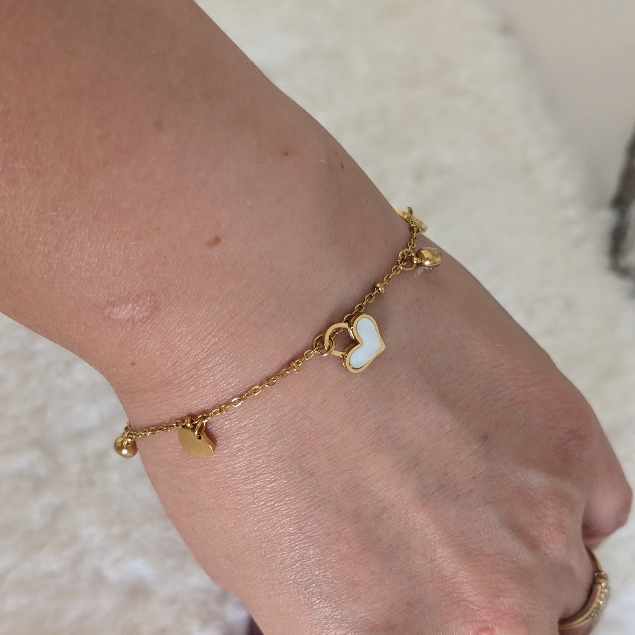 Gold anklet on a foot with a blurred background