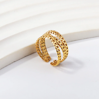 Gold chain bracelet on a white surface
