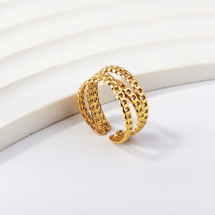 Gold chain bracelet on a white surface