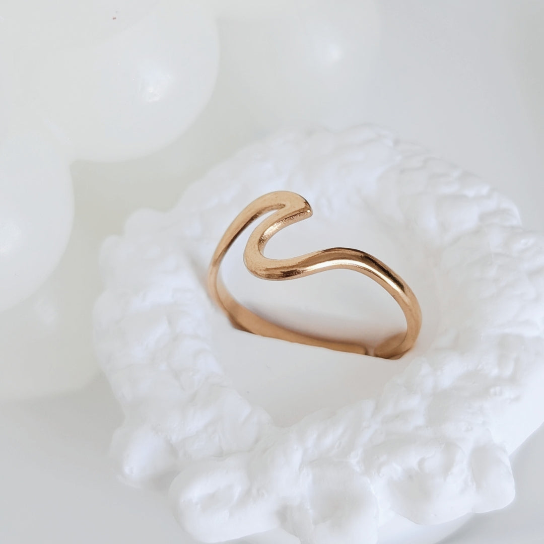 Gold ring on a textured white surface