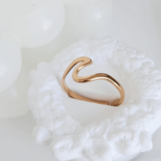 Gold ring on a textured white surface
