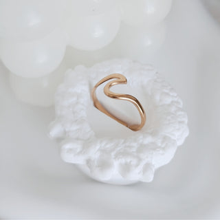 Gold ring on a textured white surface